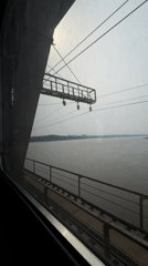 Train passenger views river and bridge in Khabarovsk