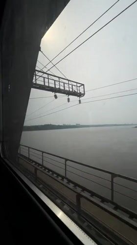 Train passenger views river and bridge in Khabarovsk