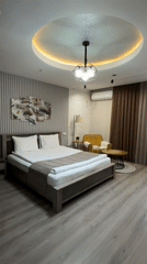 Woman jumps on hotel bed in Bishkek