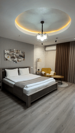 Woman jumps on hotel bed in Bishkek