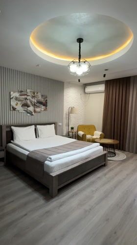 Woman jumps on hotel bed in Bishkek