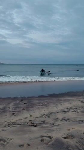 Boat rowing at dusk on Shastrawela beach, Sri Lanka