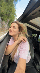 Woman rides in convertible car near rocky hillside Montenegro