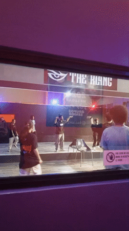 Dance crew rehearses on a lit stage in Pampatar, Venezuela
