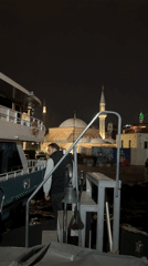 Evening boat activity near illuminated Istanbul landmarks captured