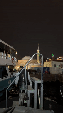 Evening boat activity near illuminated Istanbul landmarks captured