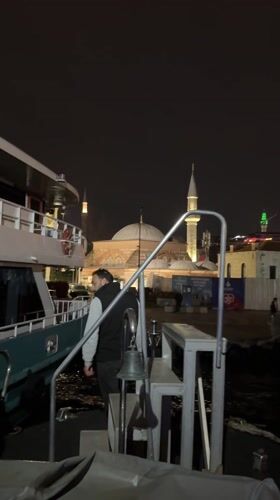 Evening boat activity near illuminated Istanbul landmarks captured