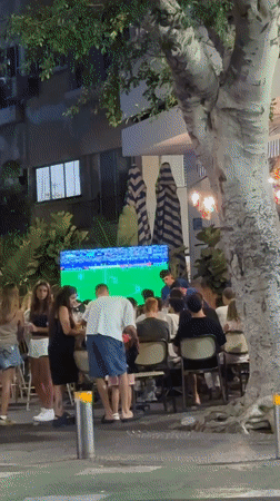 Street-level Tel Aviv: soccer crowds, shop windows, and graffiti