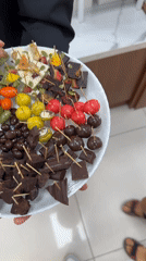 Woman shops decorative fruit ornaments at Vietnam retail store