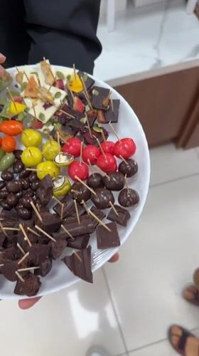 Woman shops decorative fruit ornaments at Vietnam retail store