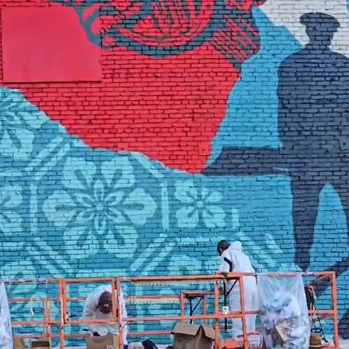 Artists paint welcome mural on Los Angeles brick wall