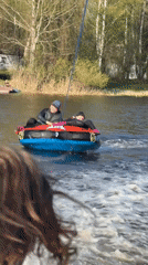 Couple enjoys tubing on Russian lake during sunny afternoon