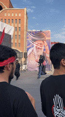 Tehran street gathering with banners and red headbands