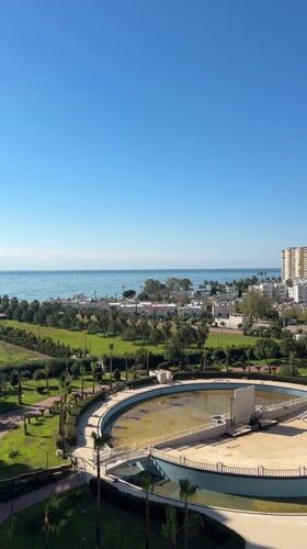 Aerial view captures coastal Erdemli, Turkey with empty pool