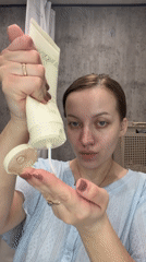 Woman documents evening skincare routine in Reshetnikovo bathroom