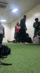 Young men gather in turf-floored indoor space in Ikeja