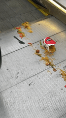 Noodle container spills across Amsterdam escalator steps