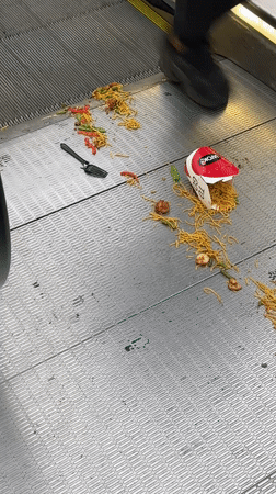 Noodle container spills across Amsterdam escalator steps