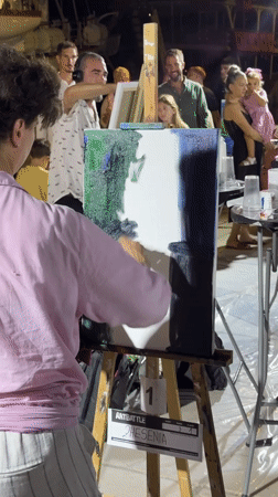 Live painting competition draws a crowd in Tivat at night.