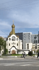 Orthodox church contrasts with modern Moscow apartment buildings