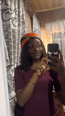 Woman takes selfies in mirror wearing headscarf in Jos