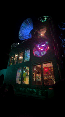 Colorful lights illuminate brick building in Indio at night