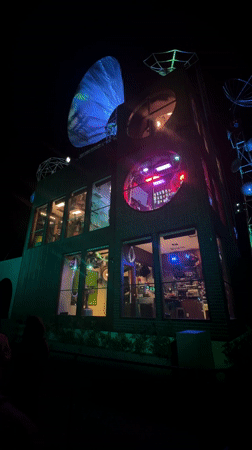 Colorful lights illuminate brick building in Indio at night