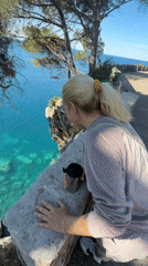 Woman walks scenic coastal path in Montenegro morning