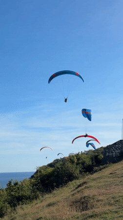 Morning paragliding session launches over Kuta Selatan coastline