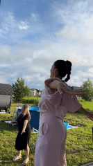 Young women dance at outdoor summer party in Zav'yalovo