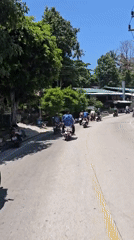 Scooter group rides through Ko Tao streets at dawn