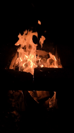 Campfire burns in brick enclosure in Shabury, Russia