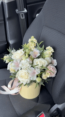 Flower bouquet in yellow box photographed in Izhevsk car