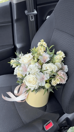 Flower bouquet in yellow box photographed in Izhevsk car