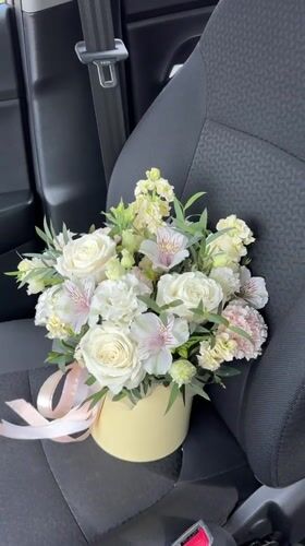 Flower bouquet in yellow box photographed in Izhevsk car