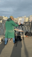 Artist paints, child plays near Moscow's decorated Luzhkov Bridge