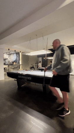 Evening indoor moments captured in Budva: pool games, pet embrace