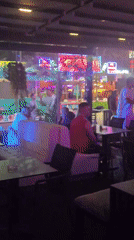 Nightclub scene with neon lighting and dancing