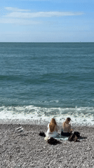 Quiet afternoon captured at Étretat beach with visitors, boats