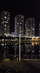 Nighttime photography session captures illuminated Kyiv waterfront and residential buildings