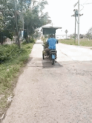 Motorbike with trailer, white car observed at city intersection