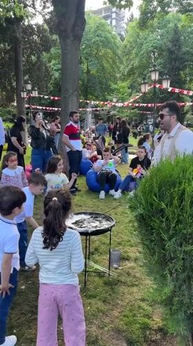 Street performer creates giant bubbles for children in Tbilisi park