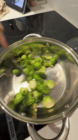 Couple with water bottles captured in mirror reflection, Larnaca