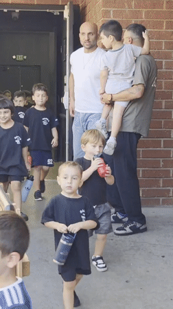 Kids lined up outside a Glendale building on a summer day