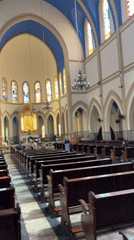 Inside a São Paulo church with blue ceilings and stained glass