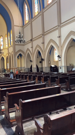 Inside a São Paulo church with blue ceilings and stained glass