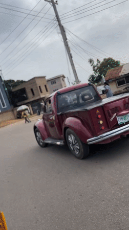 Custom red pickup truck spotted on Jos street