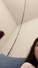 Woman plays with poodle in Montenegro home