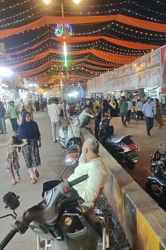 Mumbai street scene shows festival decorations with orange fabric