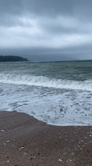 Rough seas crash against beach barrier during stormy weather